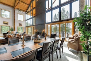The formal dining area takes center stage in this grand space, featuring a large table surrounded by ten elegant chairs, ideal for hosting meals and celebrations.