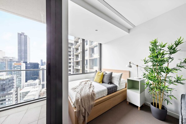 The queen sized bed with a view over Melbourne city.