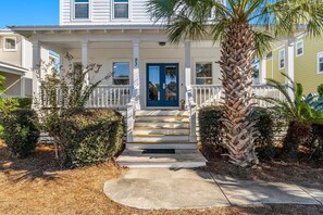 Front exterior with large wrap around porch with rockers and a porch swing 