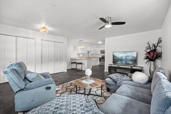 Large open livingroom and kitchen with fireplace.