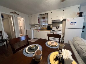 A quaint dining area that provides a lovely view of the bayou, perfect for enjoying meals with a natural backdrop.