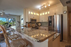 Large Fully Equipped Kitchen features a breakfast bar for four