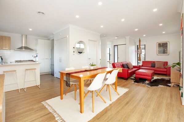 Light-filled open plan dining, kitchen and lounge room