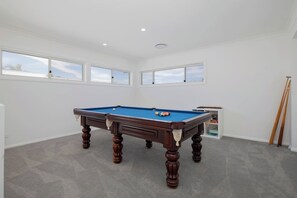 Enjoy the bright and spacious upstairs rumpus room, perfect for lively games around the beautifully detailed pool table, with board games neatly stored nearby for extra fun.