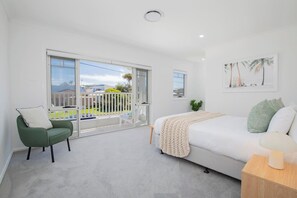 The second bedroom includes a queen-size bed and a private balcony, with central air conditioning and heating available for year-round comfort.