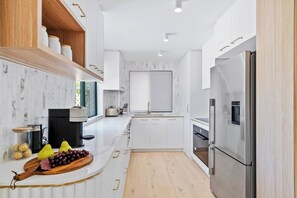 Cook up a storm in the fully equipped kitchen, complete with high-end appliances, ample counter space,  thoughtful details and a Nespresso Vertuo machine.