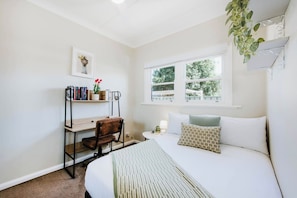Sleep easy in the third bedroom. It comes with a double bed, built-in wardrobe and a desk for some remote working.
