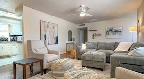 Main living room with glimpse of kitchen