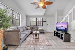 Spacious living room with a cozy sectional and bright natural lighting.