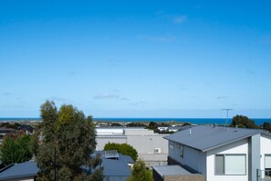The rooftop terrace offers expansive views of the ocean and passing ships