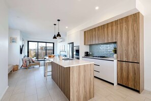 Fully equipped with modern appliances, including a gas cooktop, electric oven, and dishwasher, plus everything you need to cook and entertain