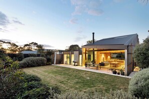Open-plan living and dining open up into the back covered terrace and lawn 