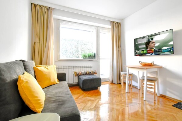 Relax on the comfortable sofa while streaming your favorite shows on the mounted flat-screen TV. Book Your Stay Today!