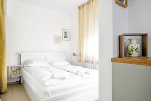 Unwind in this serene and bright bedroom, complete with fresh linens and minimalist decor. Check availability now!