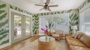 Bright and inviting sunroom filled with natural light, offering a cozy second living space perfect for large gatherings or relaxing with your group. A perfect spot to soak in the sunshine indoors!