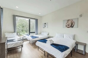 The second bedroom boasts a pair of queen beds, a twin bed, & an ensuite