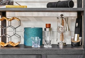 Open shelving adds character to the kitchen, displaying a mix of decor and essentials for effortless hosting and a homely feel.