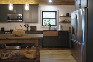 The kitchen is fully stocked for cooking and dining