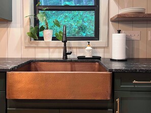 Honed granite counters and a copper farm sink for a special touch