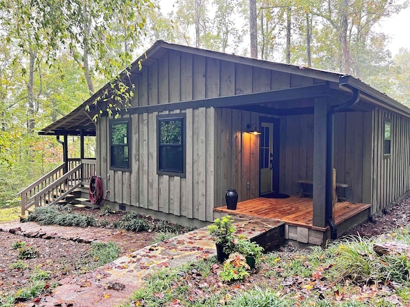 The covered side porch is used for the main entry to the Cottage.