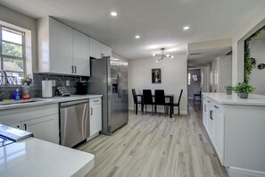 Spacious kitchen with a stylish bar counter for quick bites or morning coffee.
