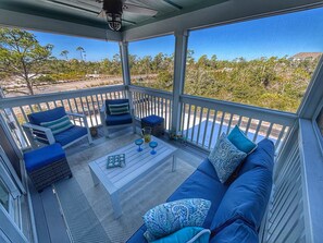 Screened porch overlooking lush views of the Nature Preserve