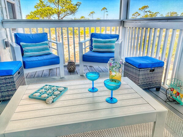 Located off the main area, enjoy the serenity of the porch...Gulf breezes melt your cares away.