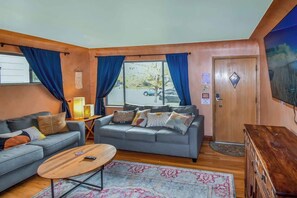 The living room exudes coziness with its inviting seating, warm decor, and relaxing ambiance—perfect for unwinding after a long day.