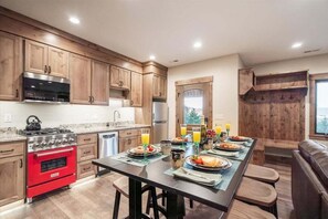Enjoy delightful meals in the fully-equipped kitchen featuring premium appliances and ample seating at Trumpeter Swan's inviting terrace-level dining area.