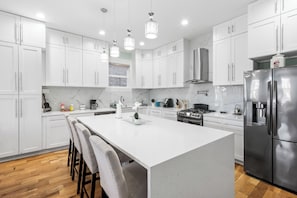 Dining table will accommodate 4 people and 4 people at the island.