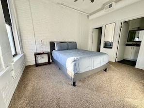 Master bedroom with queen bed and private, full bathroom