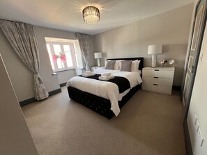 Master Bedroom with comfortable beds and black out hotel style curtains