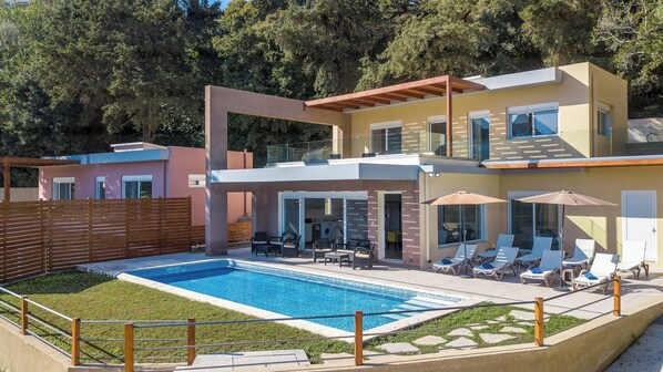 Front view of the villa. Swimming pool is located directly in front.