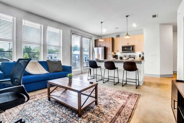 The living room is filled with natural light, creating a bright and welcoming space that invites relaxation.
