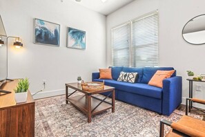 The living room is filled with natural light, creating a bright and welcoming space that invites relaxation.
