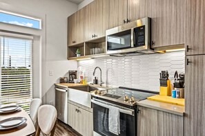 As you open the kitchen, you discover an assortment of coffee pods, and sugar, ensuring you have everything you need for a perfect morning or afternoon pick-me-up.