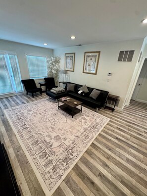 Large living room with French doors that open to backyard.