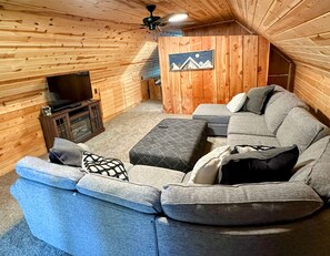 There is room for everyone to watch a movie on the comfy wrap around couch.