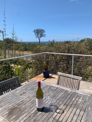 Front deck sitting area & dining with ocean views. Opens from main living space.