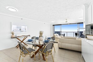 Dining area right next to the living area and the balcony overlooking the ocean