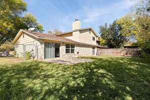 Backyard - Enjoy the simplicity of this fenced backyard, providing a versatile outdoor space for activities.