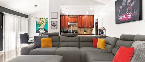 Relax in this spacious living room with a cozy sectional, ideal for lounging and enjoying quality time with loved ones.