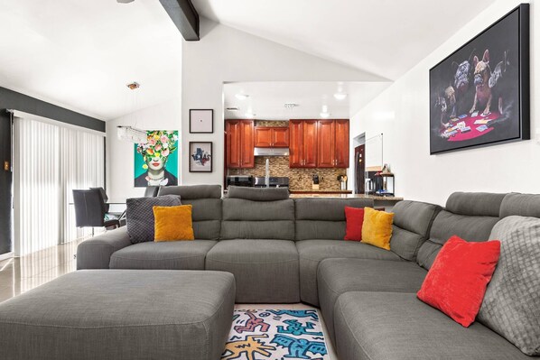 Relax in this spacious living room with a cozy sectional, ideal for lounging and enjoying quality time with loved ones.