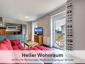 Heller und freundlicher Wohnraum mit Flat-TV und Musikanlage.