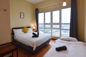 A bedroom with a queen-sized bed, single-sized sofa bed and an en-suite.