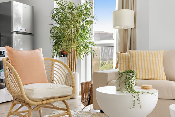 A cozy and bright seating area with stylish rattan and soft cushions