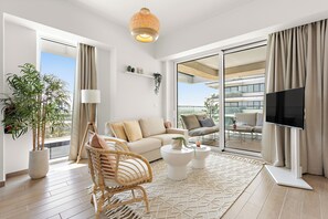 This bright, open living space features cozy seating and natural light.