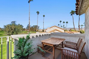 Balcony with outdoor seating and golf course view