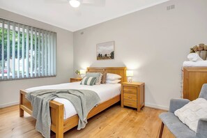 The spacious primary bedroom highlights a queen-sized bed with plenty of storage space for your belongings.
