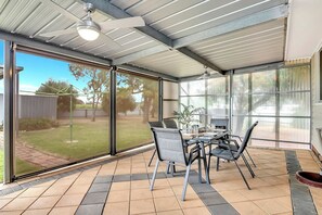 Dine alfresco on the covered patio, which opens to the garden, and make use of the BBQ.
